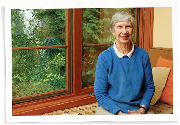 woman sitting next to windows with window inserts that fixed her drafty reading nook