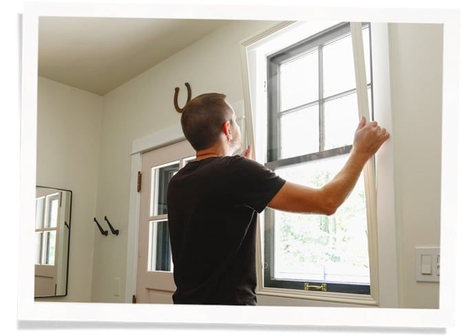 person with mask adding acoustic caulk to siding for soundproofing