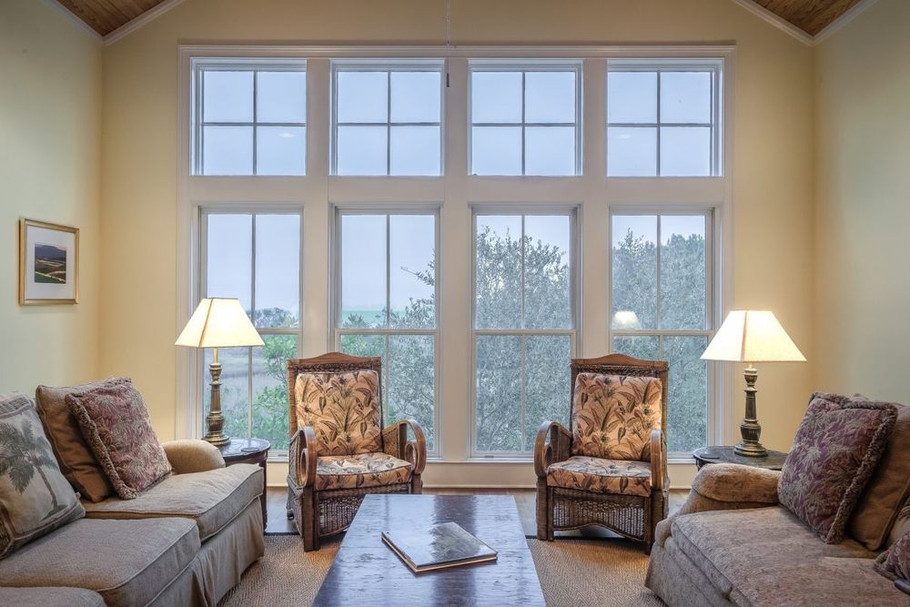 living room with large wall of windows with interior magnetic storm windows